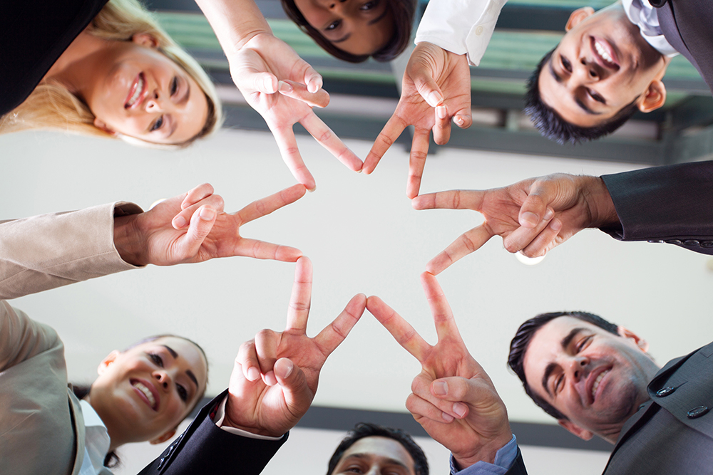 Imageofpeoplecreatingastarwithjoinedfingetips