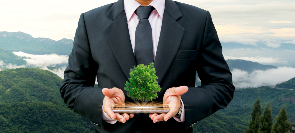 man-holding-tree-on-mobile-device