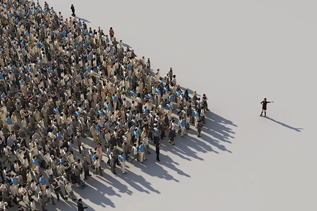 A leader points the way to a group of hundreds of people