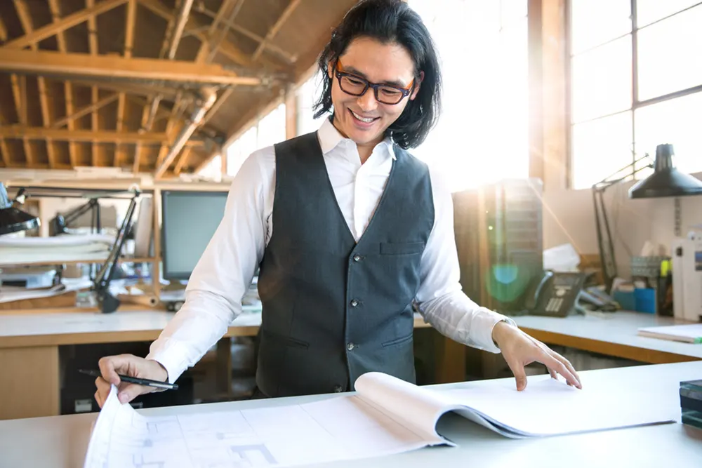 Man looks at design prints