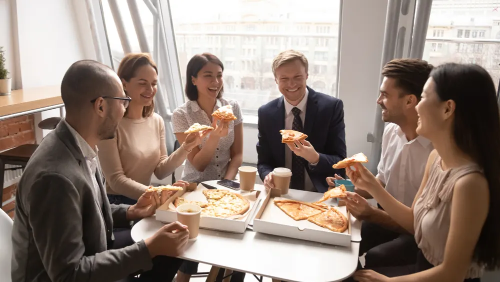 Coworkers share pizza