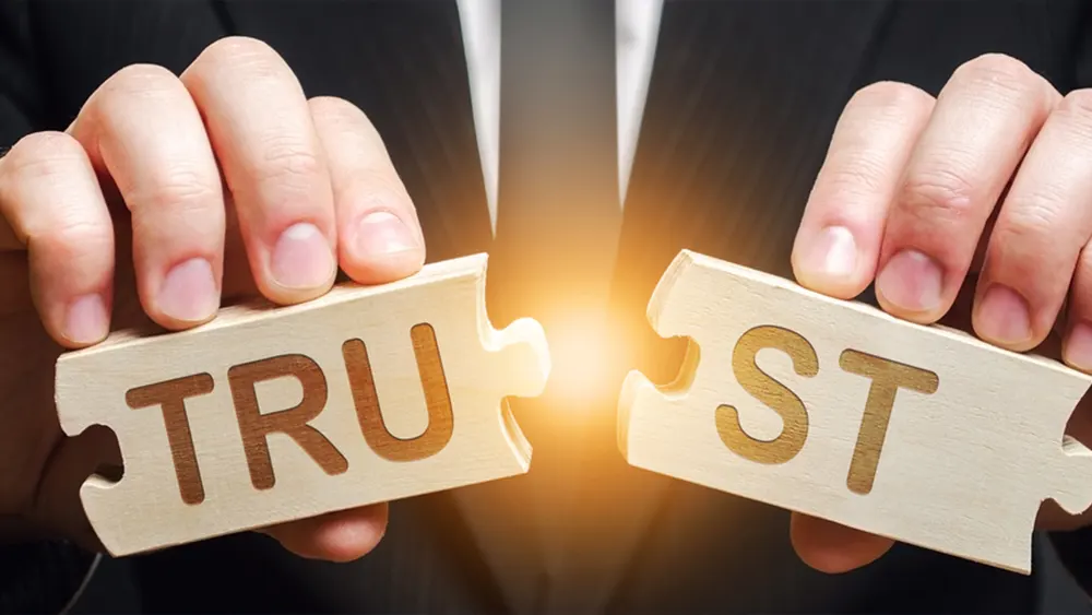 Puzzle pieces spell the word trust