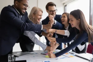 team members stack fists in celebration
