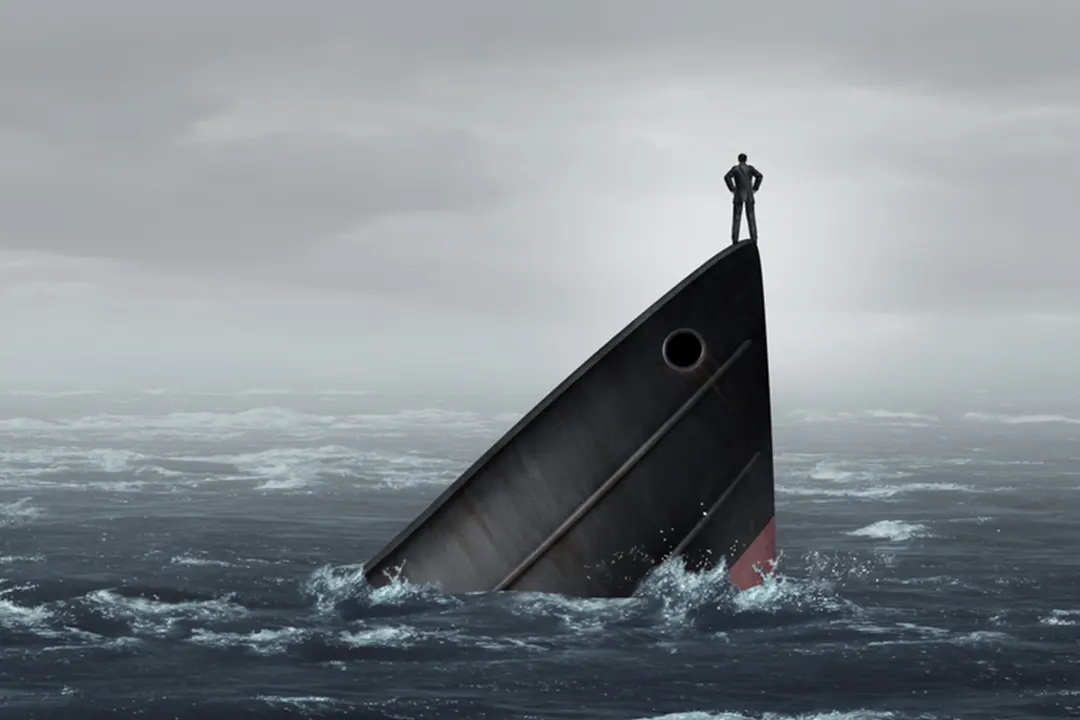 Man stands on prow of sinking ship