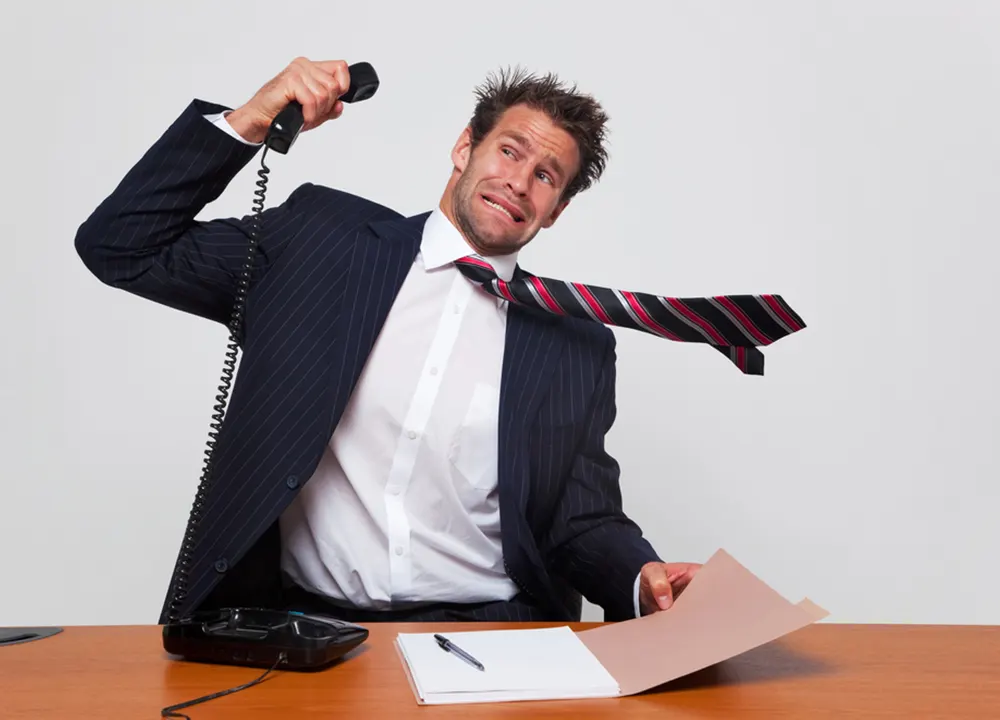 Man holds loud phone away from ear