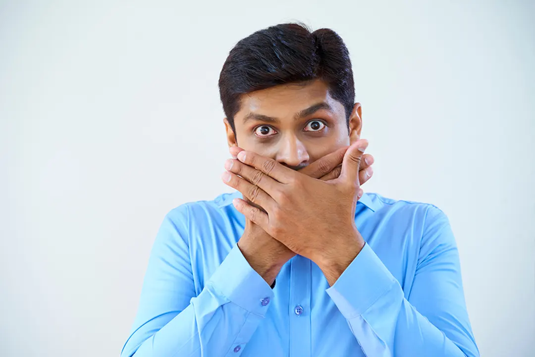 Man covers his mouth
