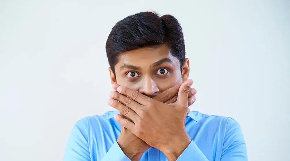 Man covers his mouth