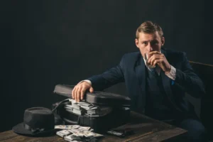 Man in suit with drink, cash, and gun