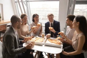 Coworkers share pizza