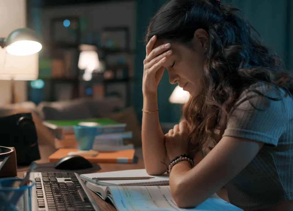 Tired woman works at home