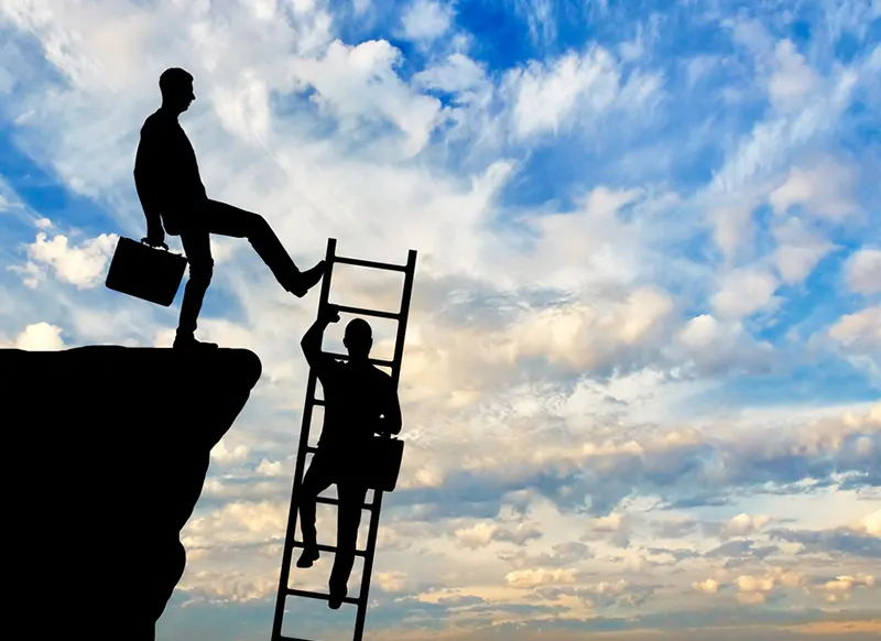 A businessman kicks a ladder that a rival is trying to climb