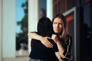 Woman hugging coworker
