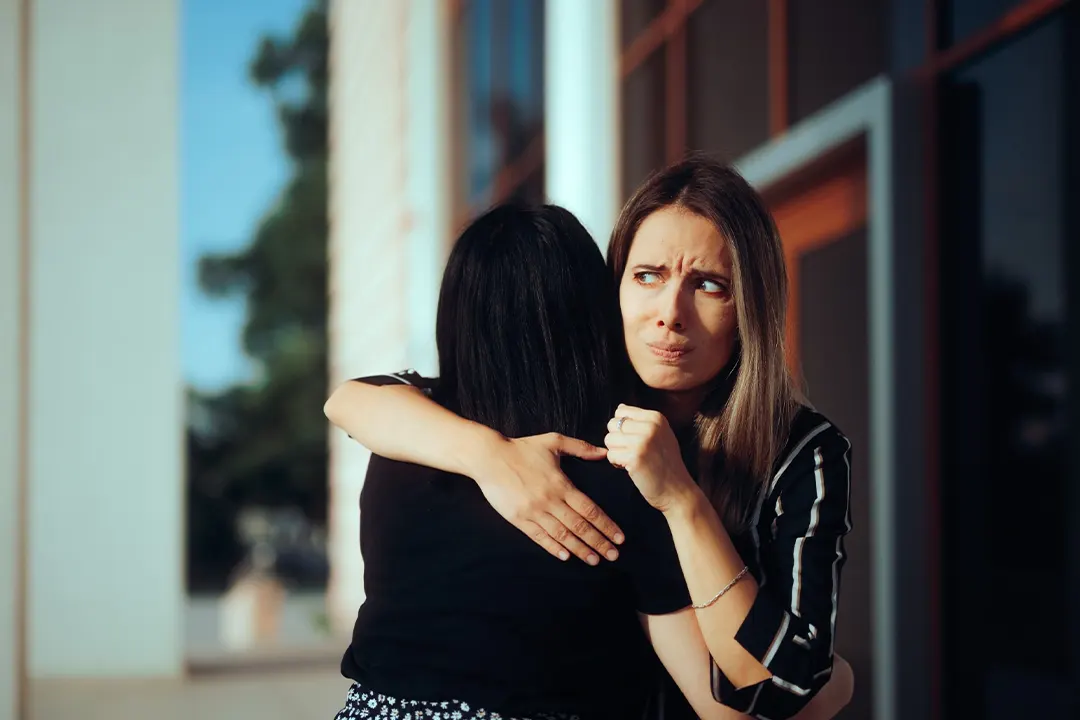 Woman hugging coworker