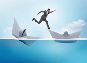 Man jumps accross two hats