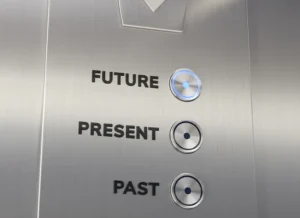 Instead of the numbers for different floors of a building, an elevator panel features buttons for past, present, and future