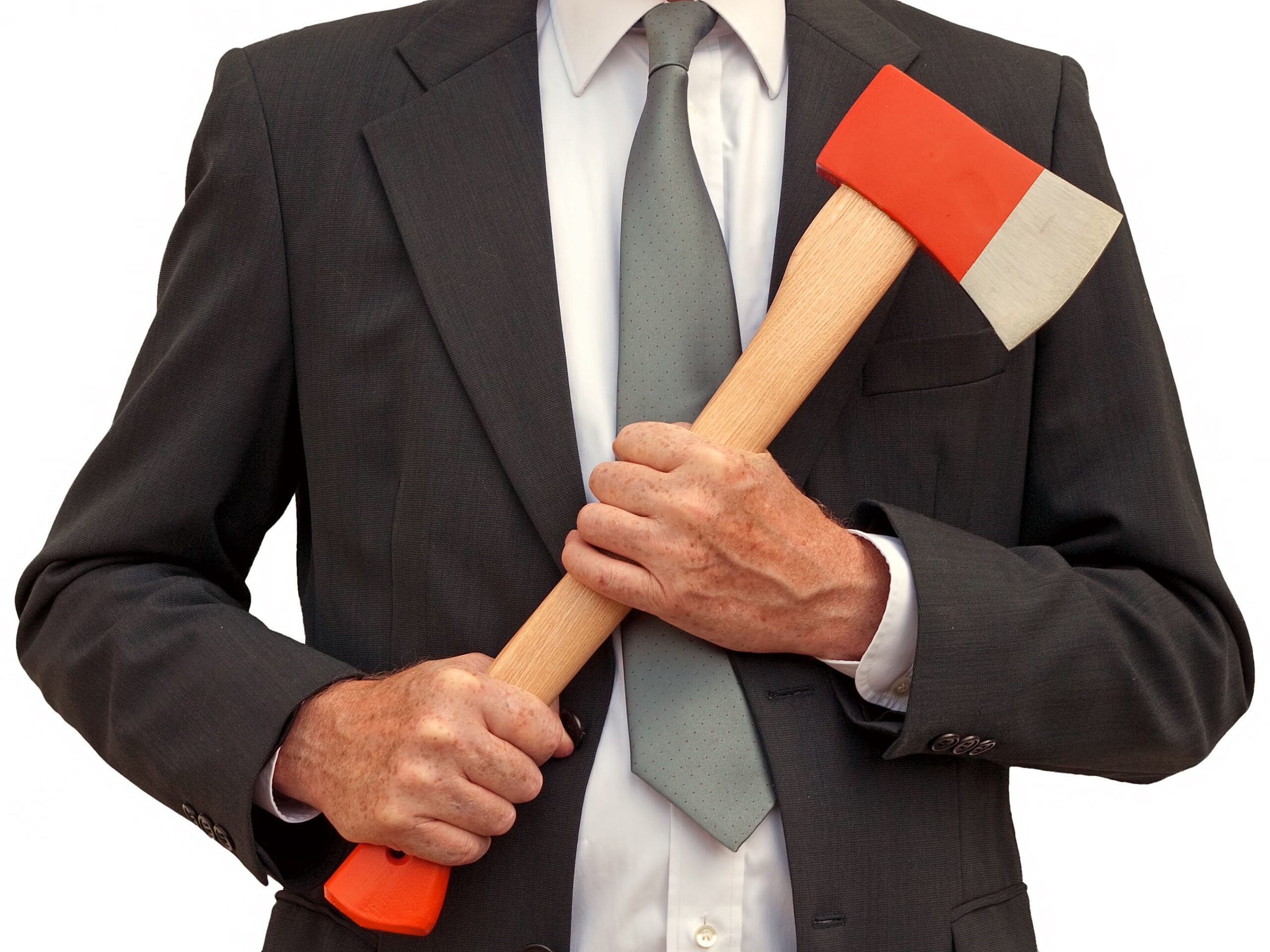 A businessman holds a red ax with a light brown handle with two hands