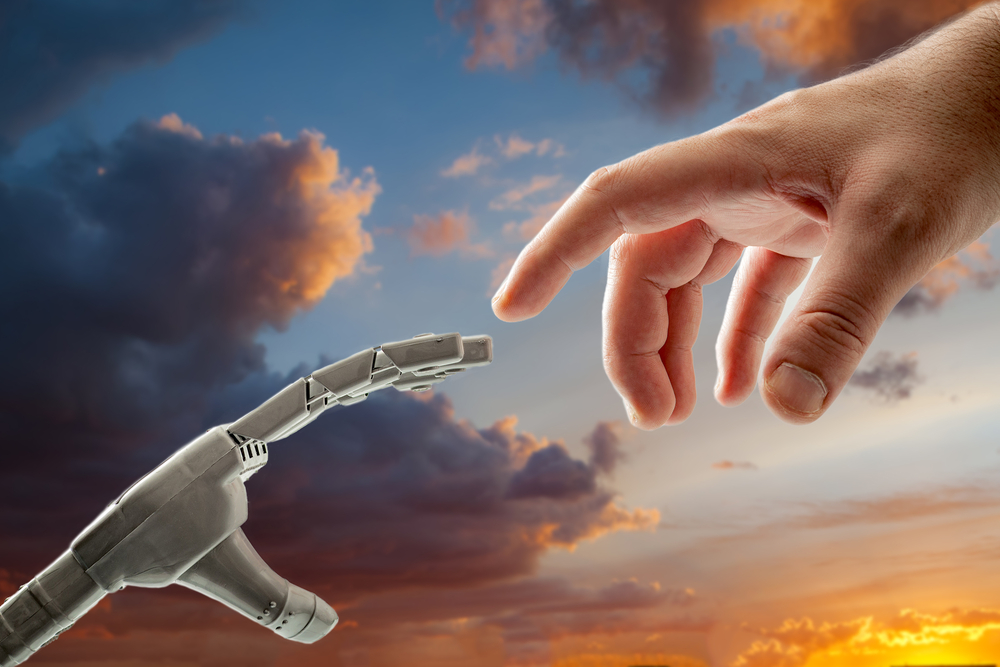 A robot hand and a human hand reach toward each other