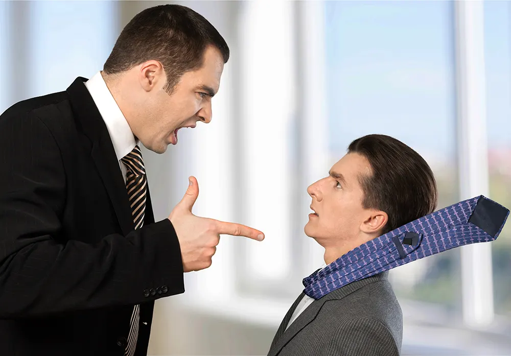 A manager in a business suit points and yells at an employee, whose tie gets blown back over his shoulder