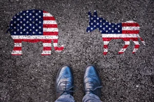 Man stands near Republican and Democrat party symbols painted on ground
