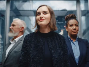 Three entrepreneurs: A white man with a white beard, a white brunette woman, and a Black woman with dark hair