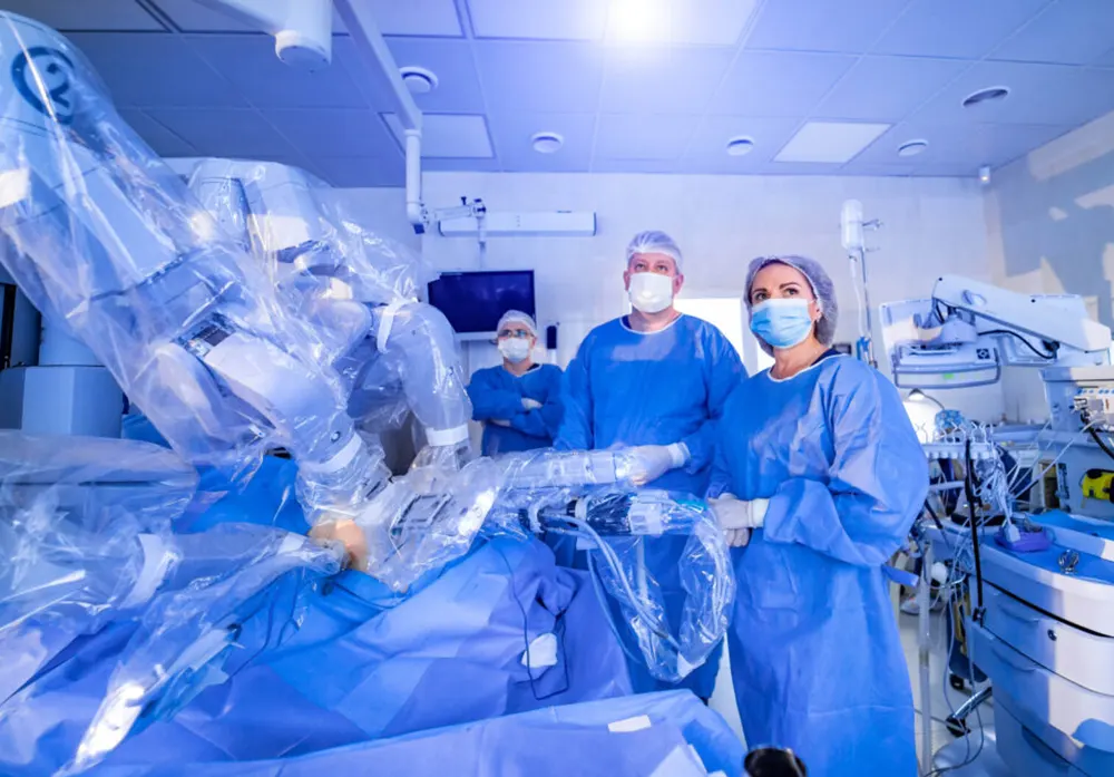 Surgeons use robotic equipment to assist in medical procedures.