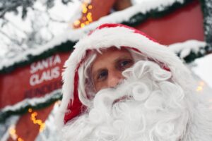 A man dressed up as Santa Claus works at a mall in the time period leading up to Christmas.