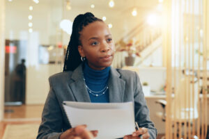 African businesswoman, paperwork and meeting for interview, assessment and discussion as employee. Female person, document and contract for onboarding, recruitment and human resources as hiring team.