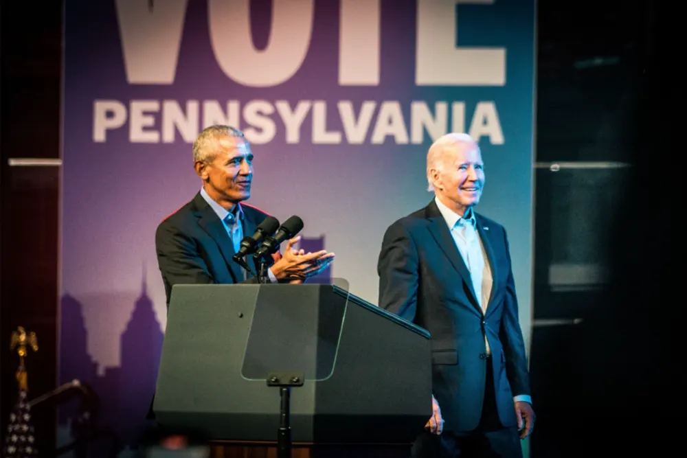 Former U.S. President Barack Obama speaks at a podium praising former U.S. President Joe Biden.