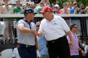 President Trump (R) shakes hands with Talor Gooch at the first tee during the LIV golf Tournament held at Trump National Golf Club in Bedminster, NJ.