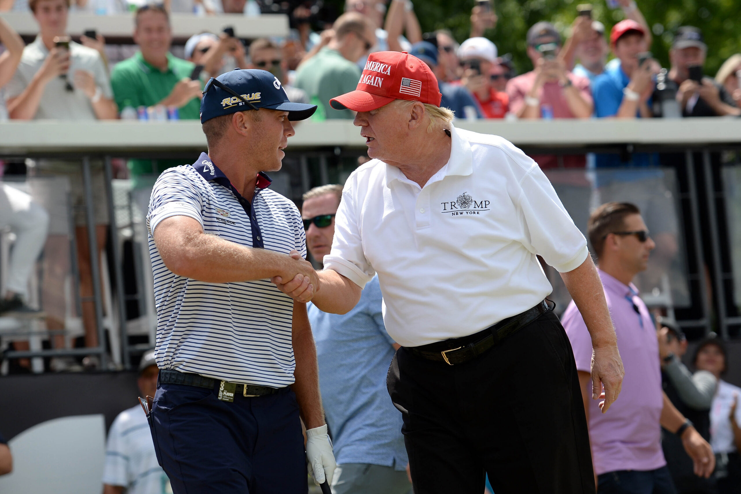 President Trump (R) shakes hands with Talor Gooch at the first tee during the LIV golf Tournament held at Trump National Golf Club in Bedminster, NJ.