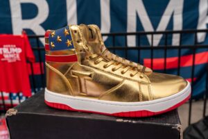 Atlanta, Georgia, USA, October 28, 2024 Vendors sell Trump election merchandise(Trump logo gold sneakers) at former President and 2024 Republican presidential nominee's rally at Georgia Tech.