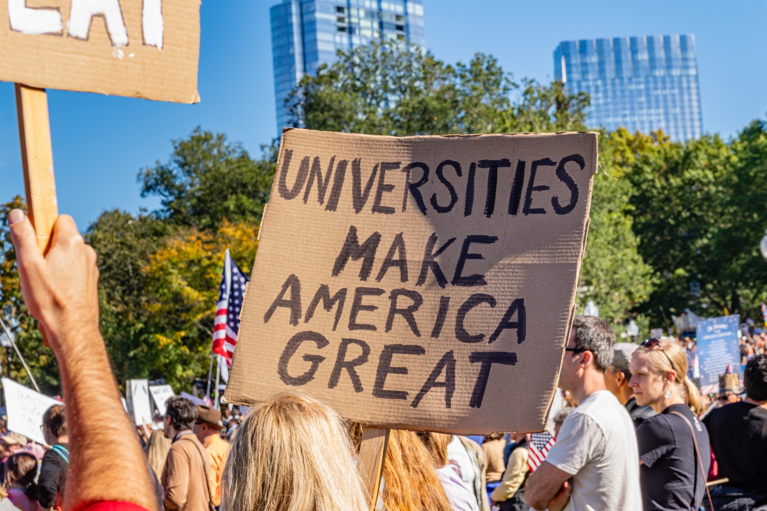 Boston, MA, US-October 18, 2025 Anti-Trump protesters with sign reading Universities Make America Great. Crowds numbered over 125,000 in Boston and up to 7 million nationwide. No Kings Protest.