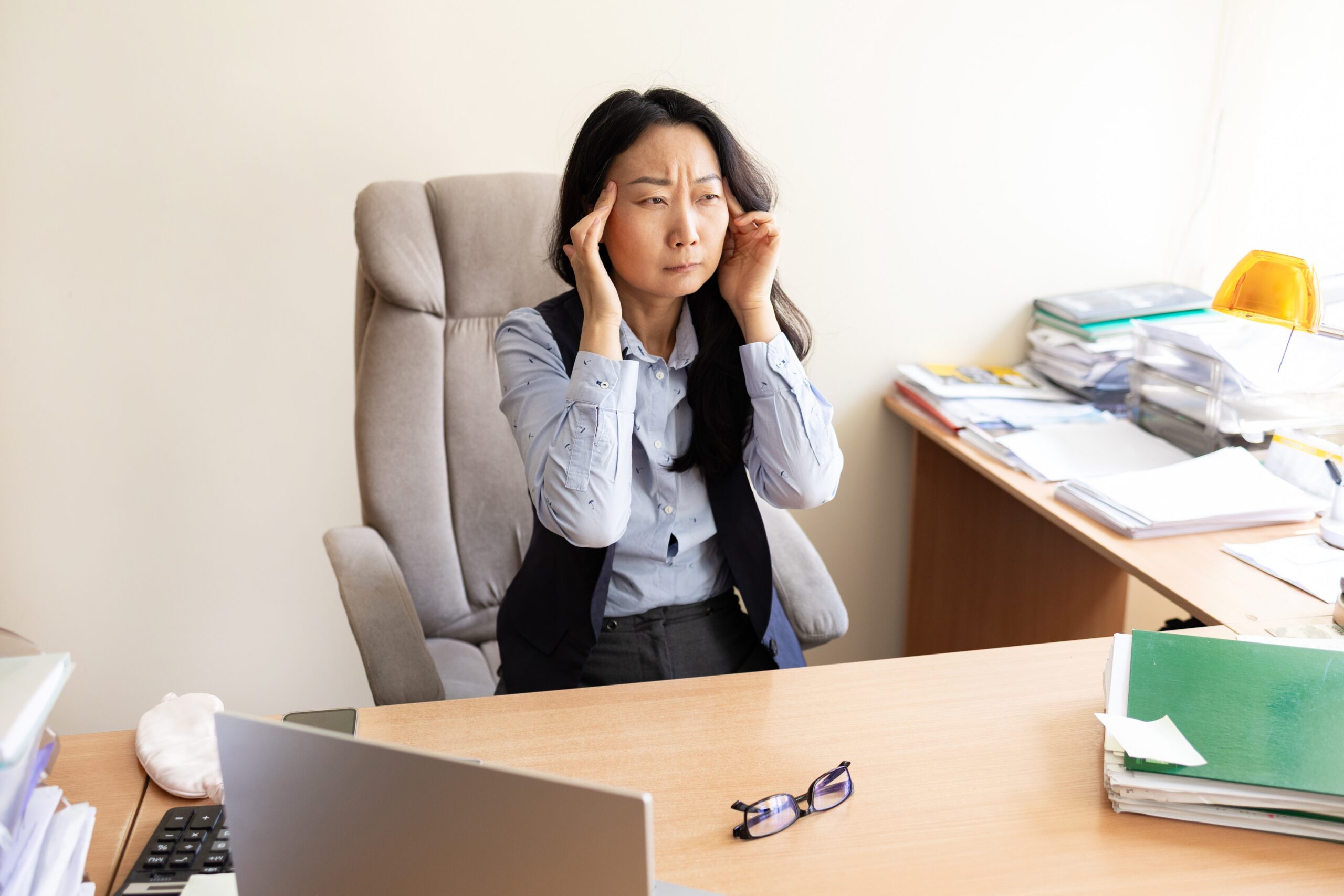 Drained restless woman going into mental haze with after hours tasks, rubbing eyes and struggling to stay awake. Employee with intense workload and discomfort feels anxious and overwhelmed.