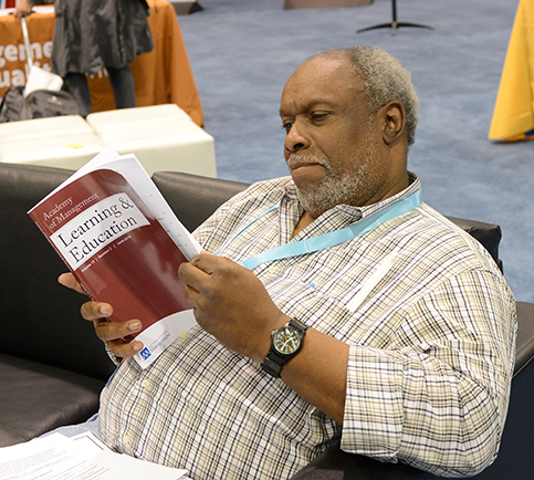 Access to research, man sitting reading AMLE