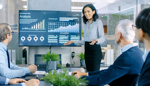 Woman presenting at a meeting in an office setting