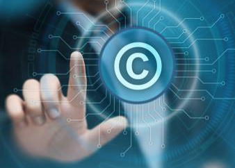 Finger pressing a "C" copyright symbol